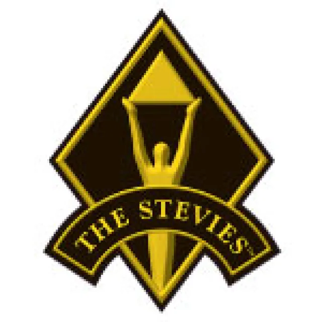 Black and gold diamond-shaped logo with a figure holding a pyramid, text reading THE STEVIES