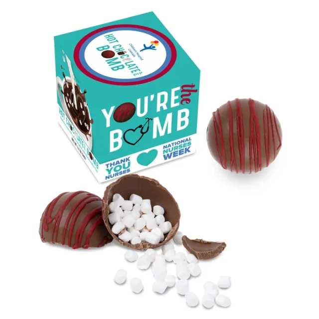 Hot chocolate bomb with marshmallows spilling out next to a teal gift box for National Nurses Week appreciation.