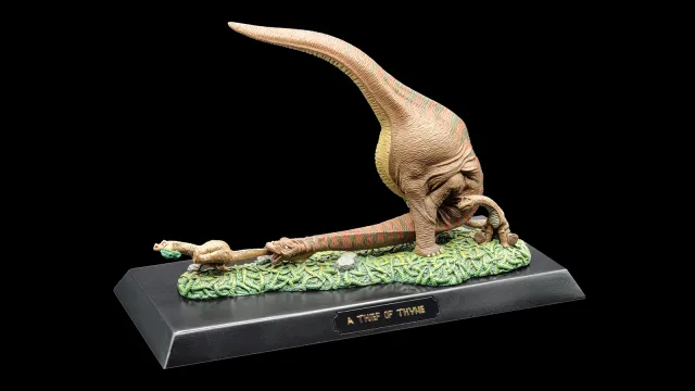 a dinosaur on a black surface