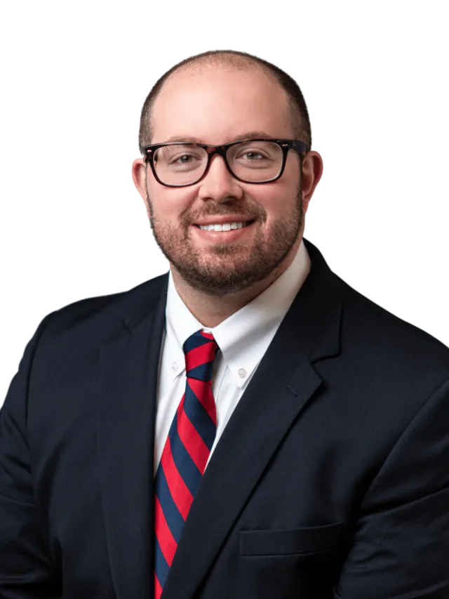 a man wearing glasses and a suit