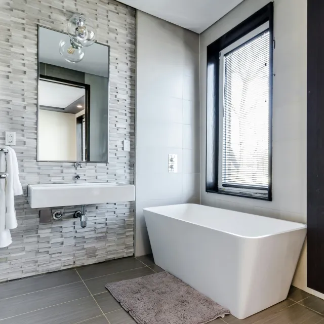 a bathroom with a tub and sink
