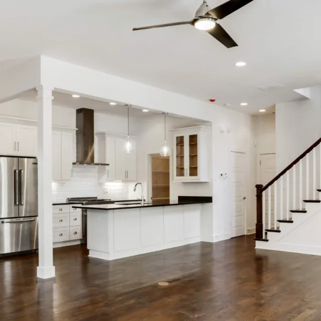 a large kitchen with a wood floor
