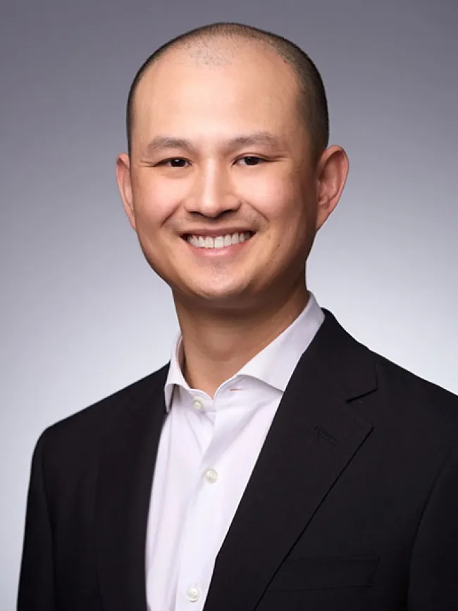 a man in a suit smiling