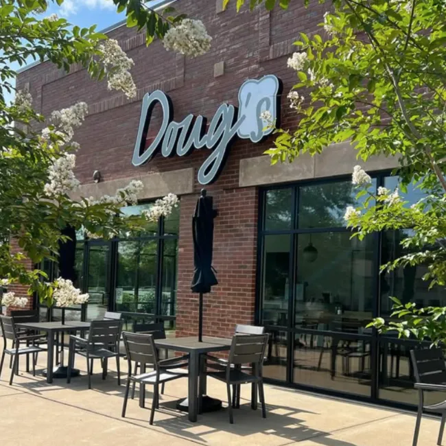 a restaurant with tables and chairs outside