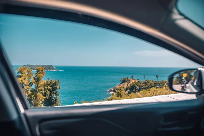 a beautiful view of the beach from a car window