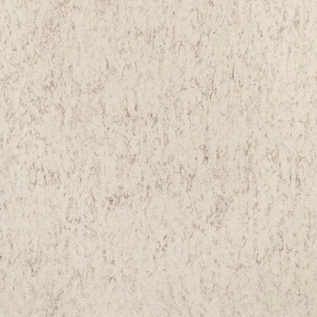 a white wall with a dark speckled surface