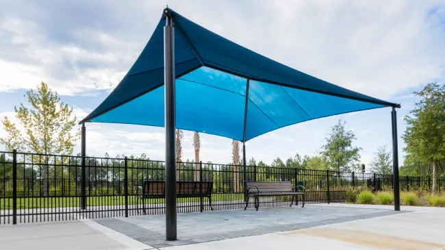 a covered area with benches and trees