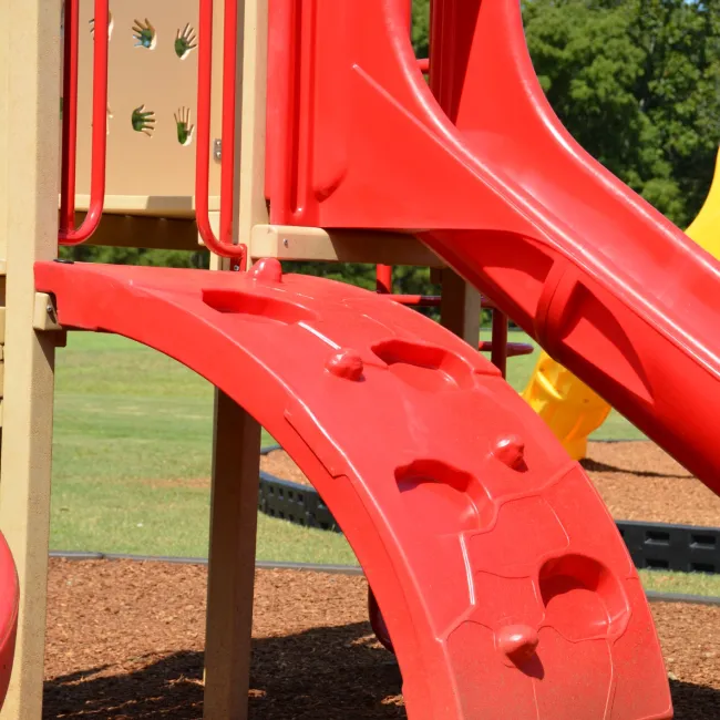 a red and yellow playground toy