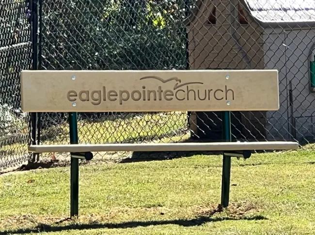 a sign on a bench