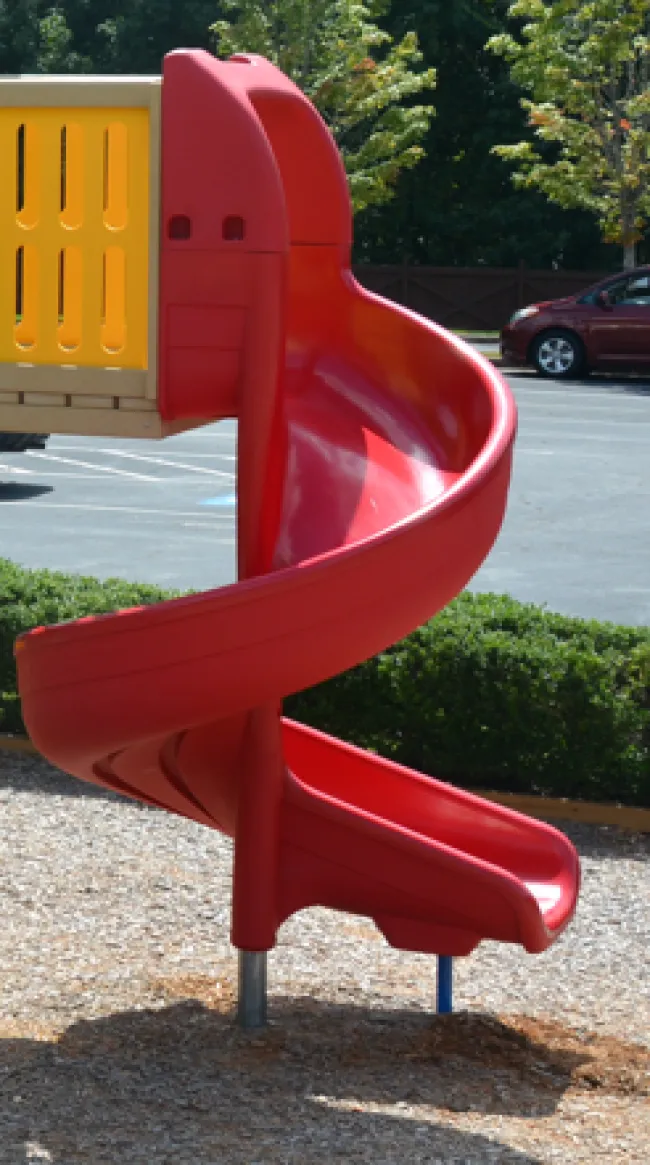 a red chair in a parking lot