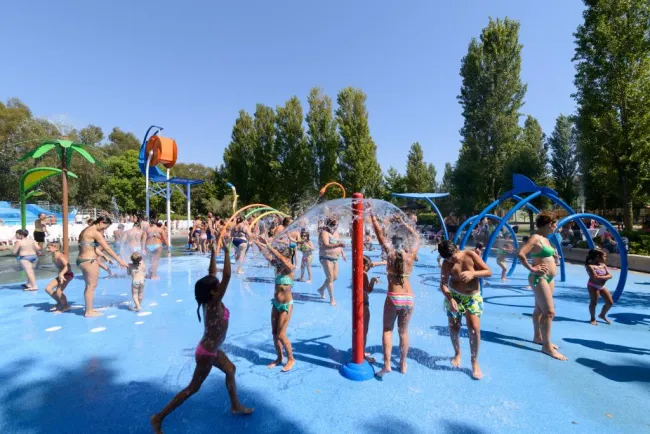 a group of people playing in a water park