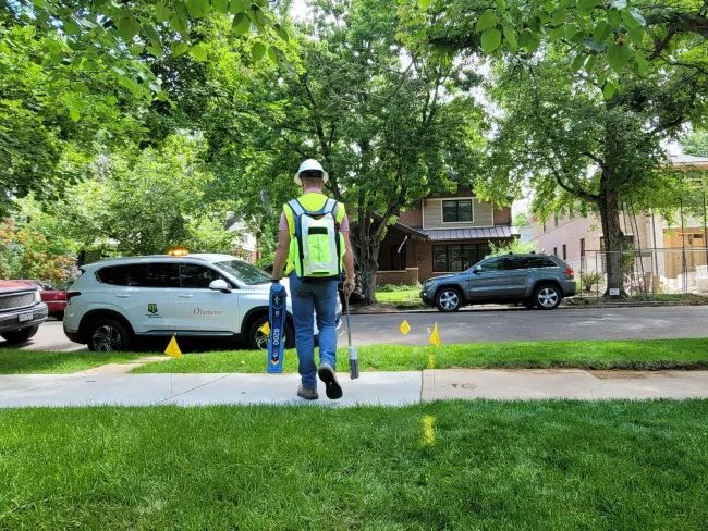 a person in a safety vest carrying a blue and white object
