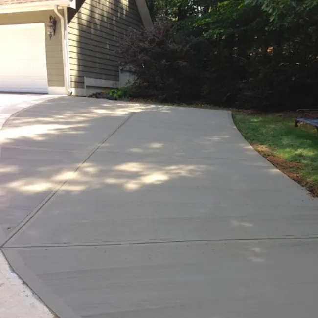 a driveway with a garage and grass