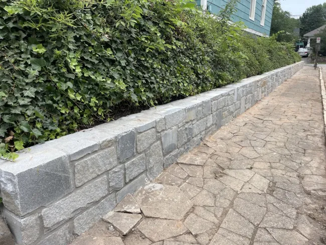 a stone wall with a stone walkway