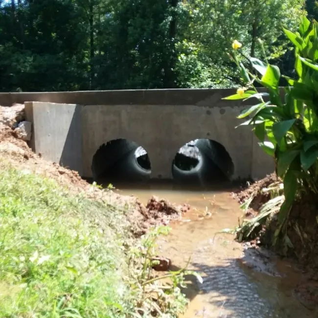 a concrete bridge over a stream