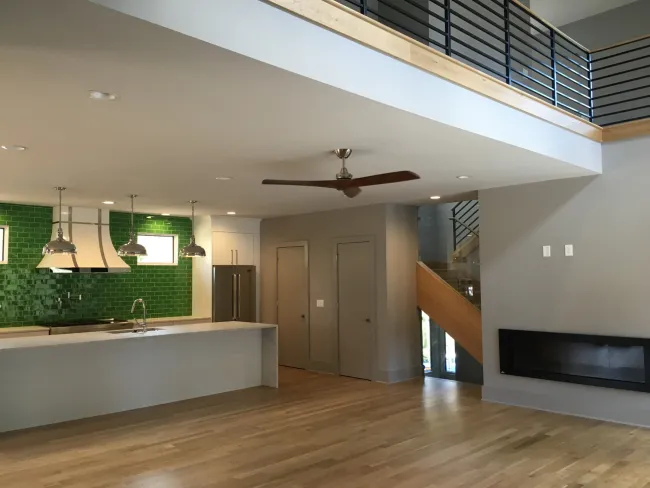 a room with a wood floor and a ceiling fan