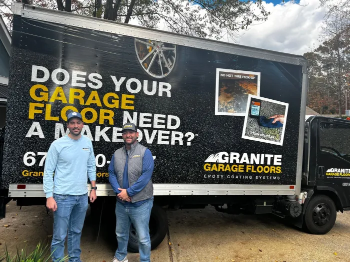 Drake Reynolds & Ricky Sanchez standing in front of a truck