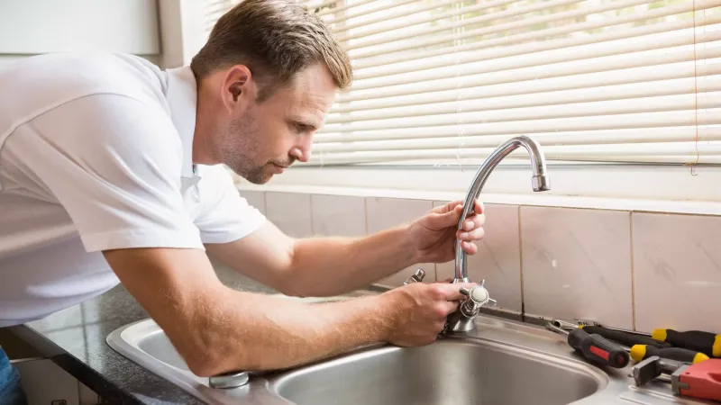 a man washing his hands in the sink