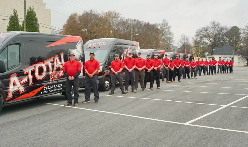 a group of people in red uniforms standing in a parking lot