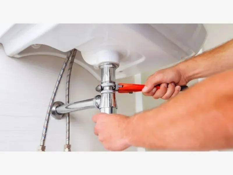 a person washing a sink