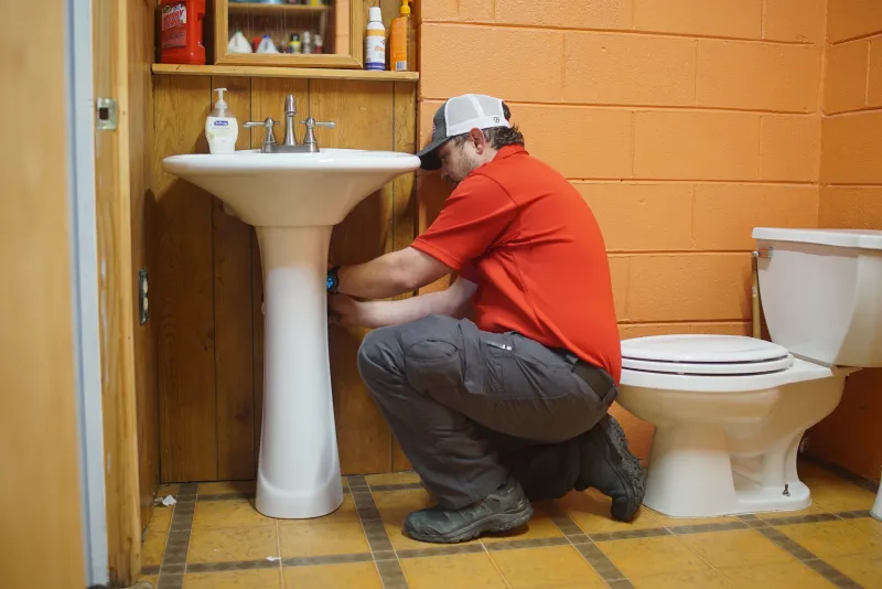a man fixing a sink