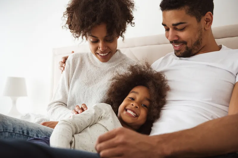 a man and a woman holding a child