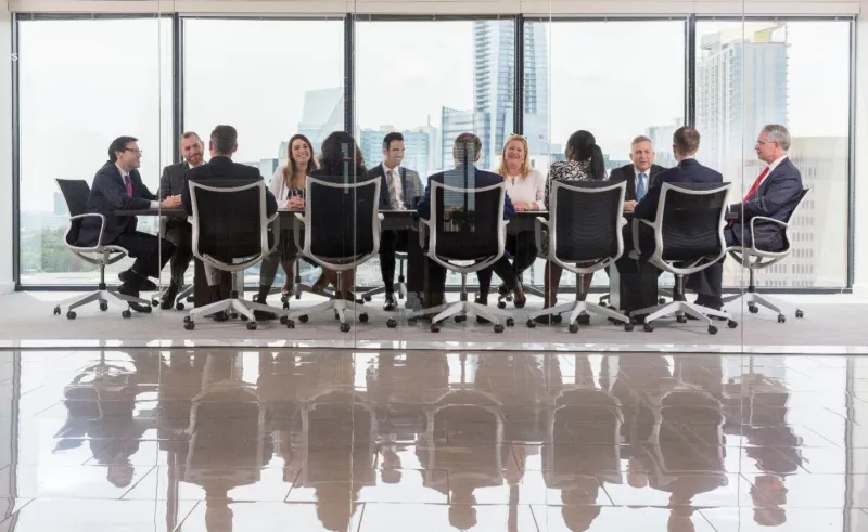 a group of people standing next to a window