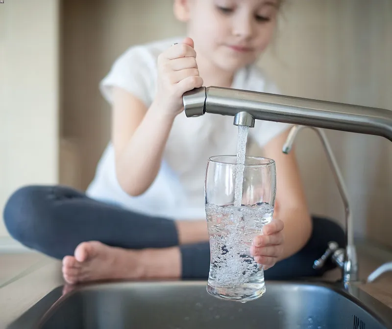 a person holding a glass of water