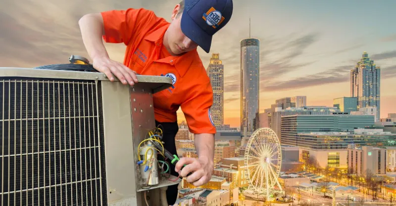 Estes Services Technician in orange uniform repairing rooftop HVAC unit with Atlanta skyline and Ferris wheel at sunset in background