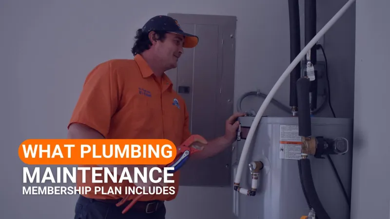 Plumber in orange uniform inspecting water heater for plumbing maintenance membership plan.