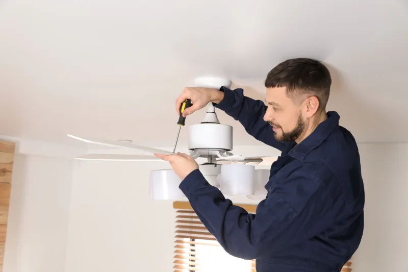 Electrician installing a ceiling fan in Sandy Springs, Georgia