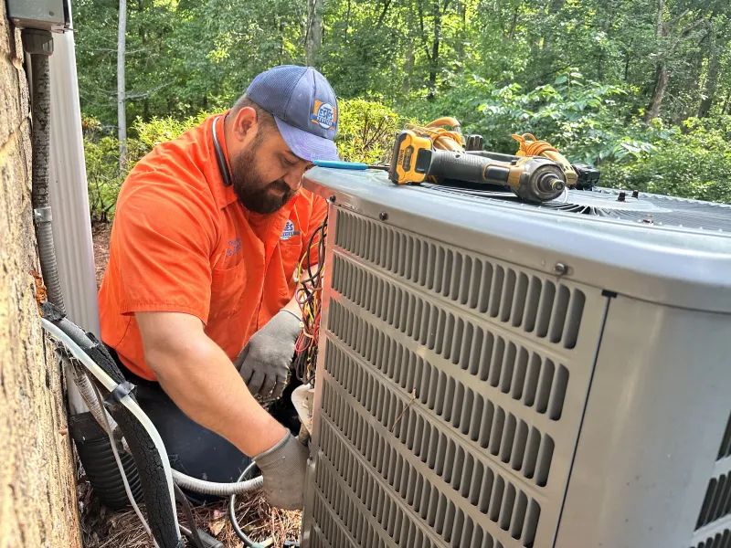 Estes Technician installing an outdoor air conditioning unit with Georgia Hear Program Rebates