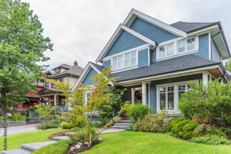 a house with trees and bushes in front of it