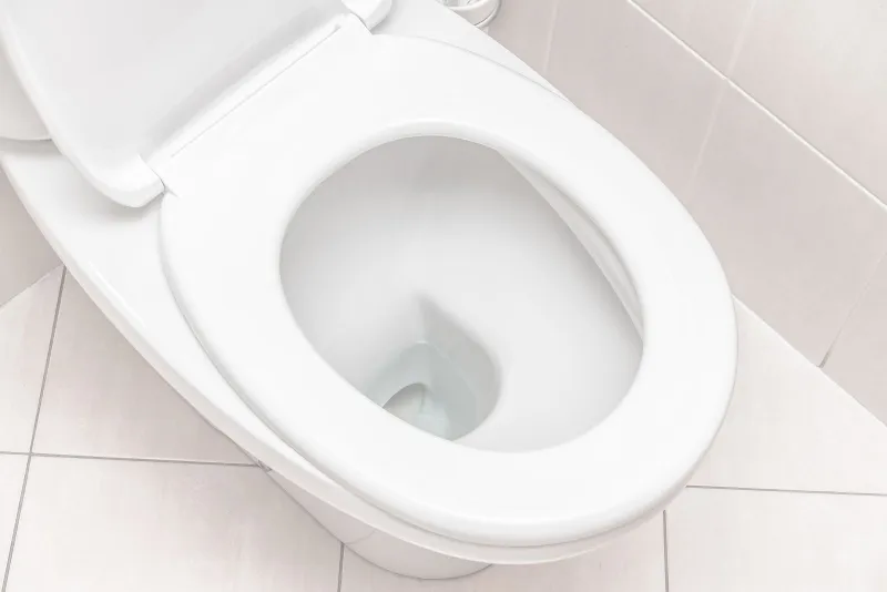 a toilet with a white seat