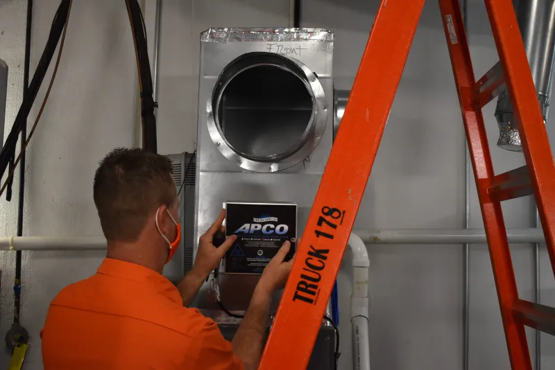 a man installing a purifier