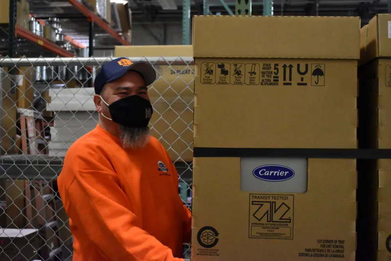 a person standing next to a box