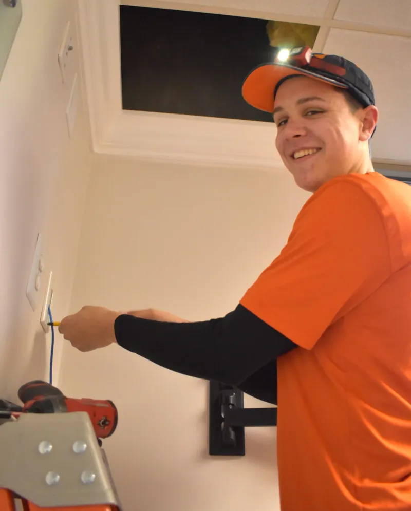 Licensed electrician installing an outlet