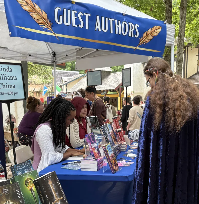 A guest author signing books at Arte of the Booke