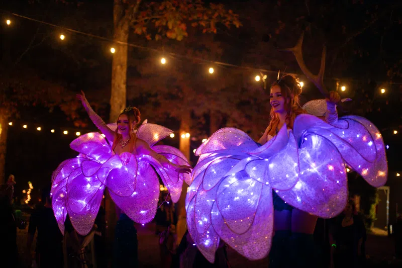 Stilt performers in bloom costumes at GARF After Dark