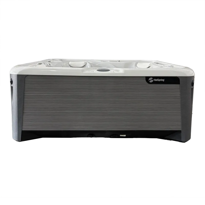 Modern HotSpring hot tub with gray wood panel siding and white interior seating for relaxation