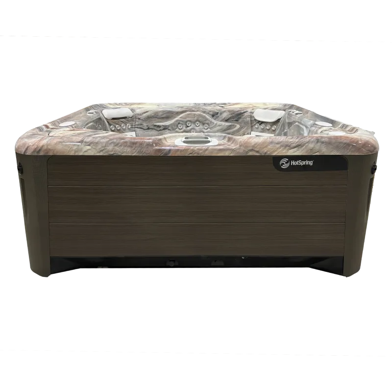 HotSpring outdoor hot tub with marble patterned interior and wood finish exterior panel