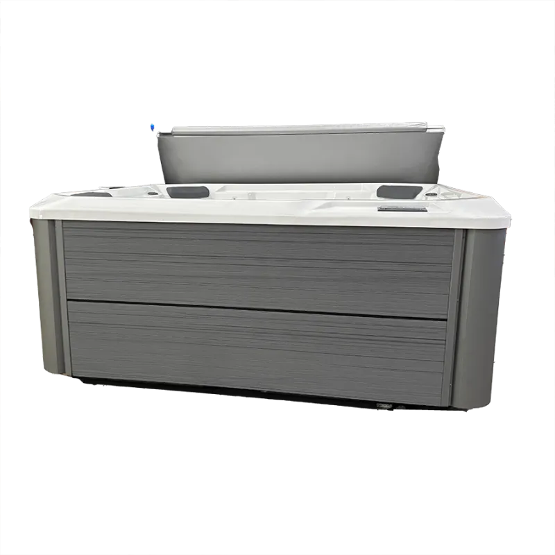 Modern gray outdoor hot tub with white interior and partially opened cover on black background