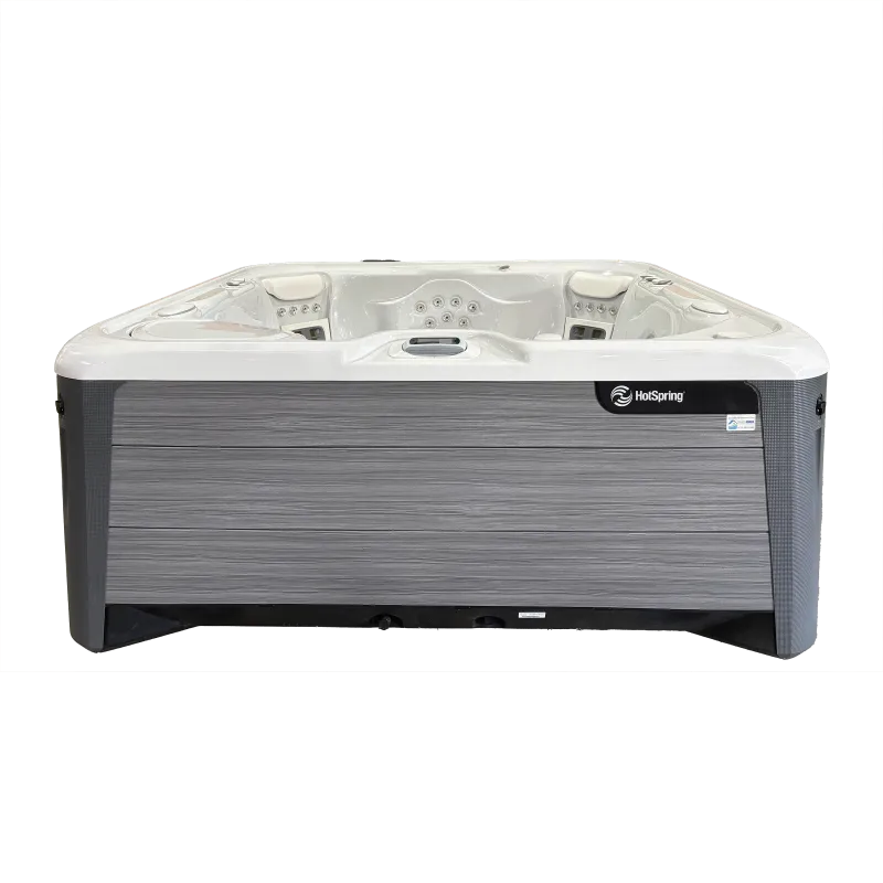 Modern HotSpring hot tub with grey wood panel exterior and multiple seating jets for relaxation.
