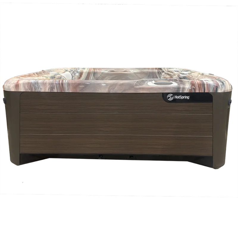 Rectangular HotSpring hot tub with wooden exterior panels and marble-patterned interior, designed for relaxation.