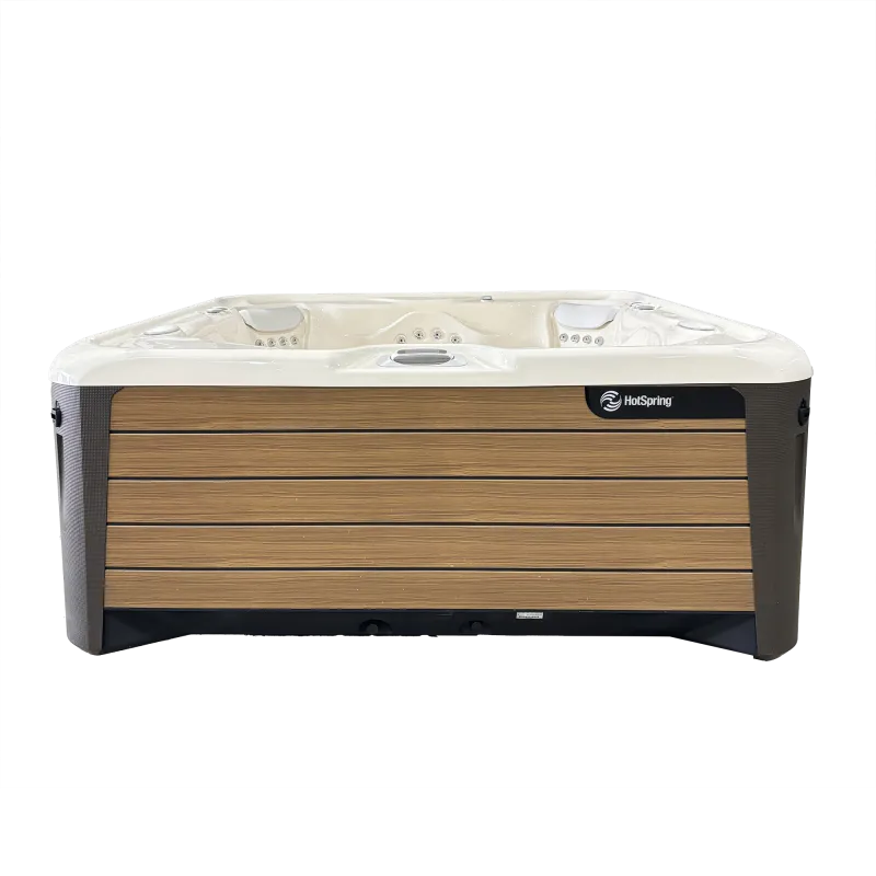 Modern HotSpring spa with wooden panel exterior and white interior featuring multiple jets and seating.
