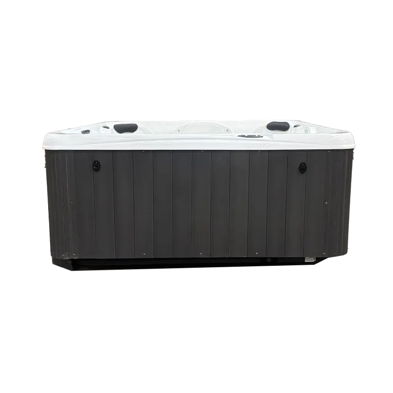 Modern rectangular outdoor hot tub with white interior and dark gray exterior panels isolated on white.