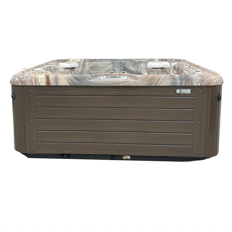 Modern rectangular hot tub with wood-paneled sides and marble-effect interior featuring built-in jets and headrests.