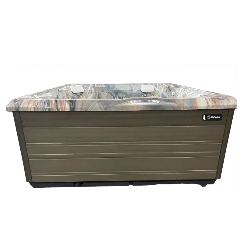 Modern rectangular HotSpring spa with marble-patterned interior and brown exterior panels, equipped with headrests and controls.