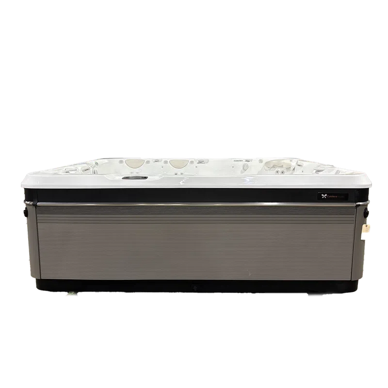 Modern rectangular outdoor hot tub with gray paneling and white interior seating against a white background