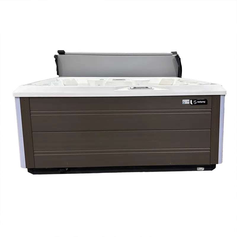 Outdoor HotSpring spa hot tub with brown exterior panels and white interior, cover partially open